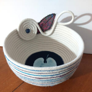 round cotton rope bowl, dark blue leaf in center, with swirl, loop, and quilted leaf embellishments on the side